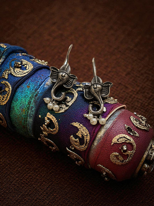 Decorative scroll with intricate designs and jewelry on a brown background